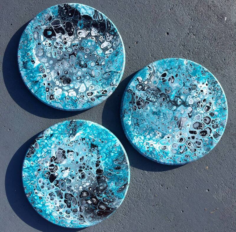 Round acrylic pour paintings with shiny epoxy on top.