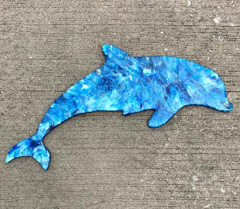 Blue resin dolphin wall art.