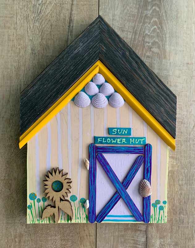 Small beach cottage wall art with sunflower and seashell theme.