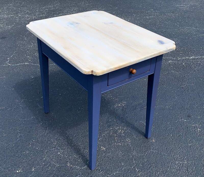 Navy blue end table with sanded, weathered top.