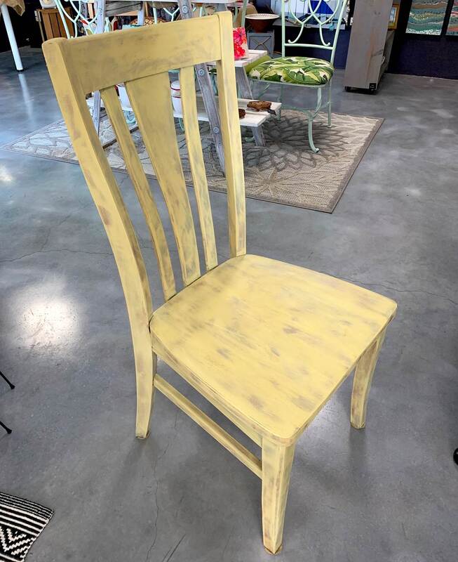 Single yellow wooden side chair.